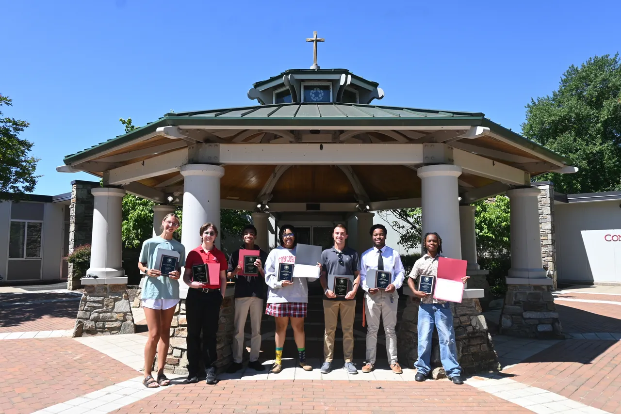 Saints who were recipients of the year-long core value awards standing in front of the gazebo.