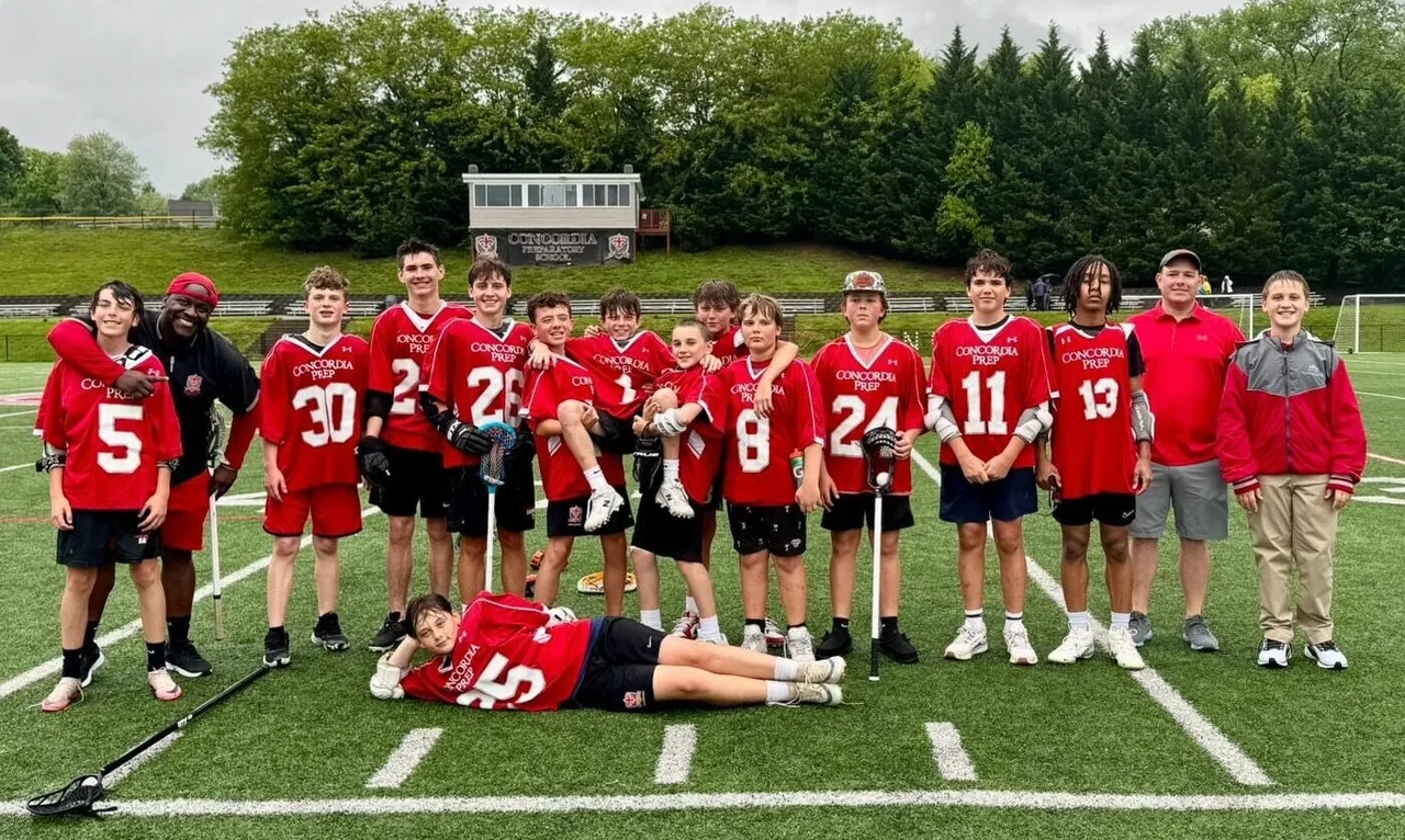 Students gathered in uniforms with lacrosse gear posing for photos.