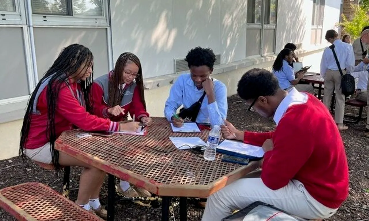 A group of students studying outside.