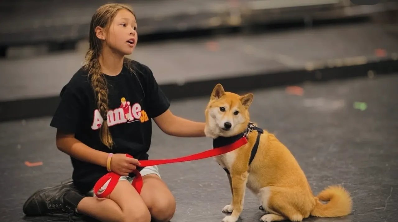 Camper performing with dog during theatre camp.