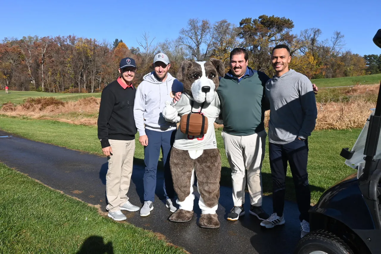 Alumni posing for photo at the annual Saints Golf Tournament