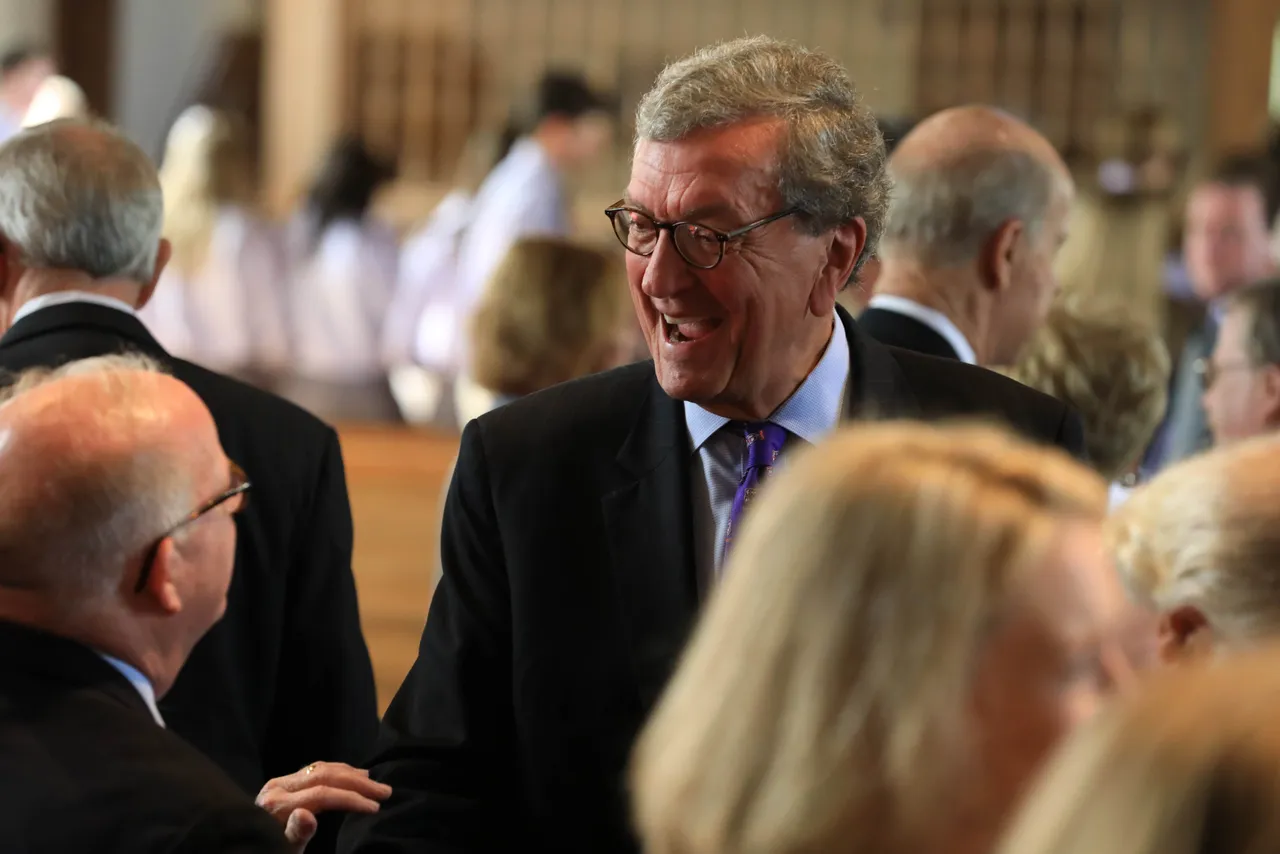 Darlington alumnus Lee Thuston smiles while speaking with people.