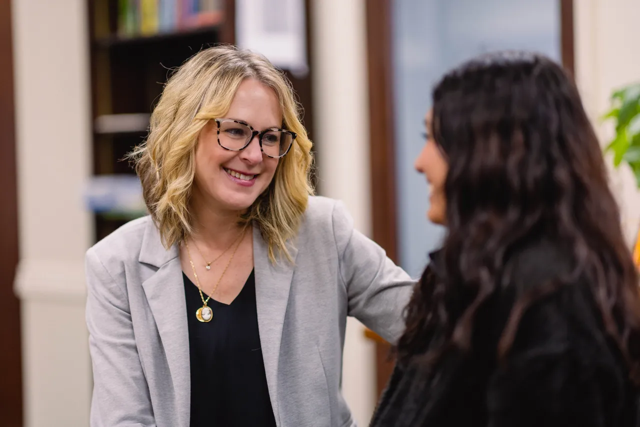 A female teacher talks with a female high school student in the Teaching and Learning Center