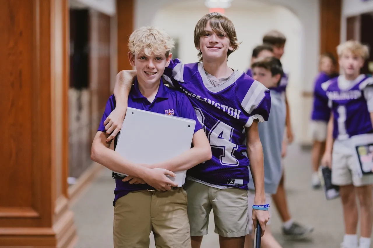 Two middle grades students walking down the hallway during break