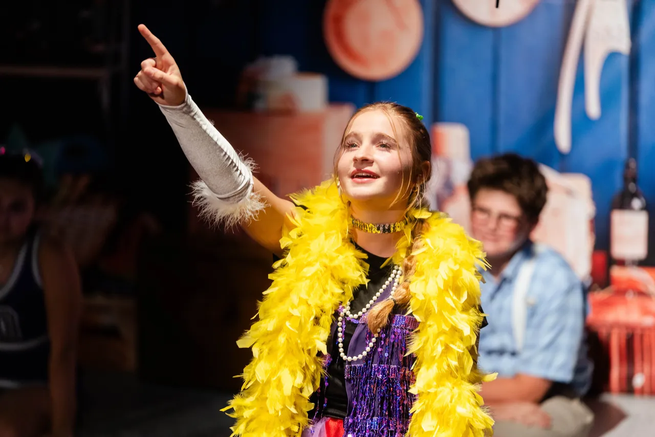 Female middle school student performs in a theater production at Darlington School