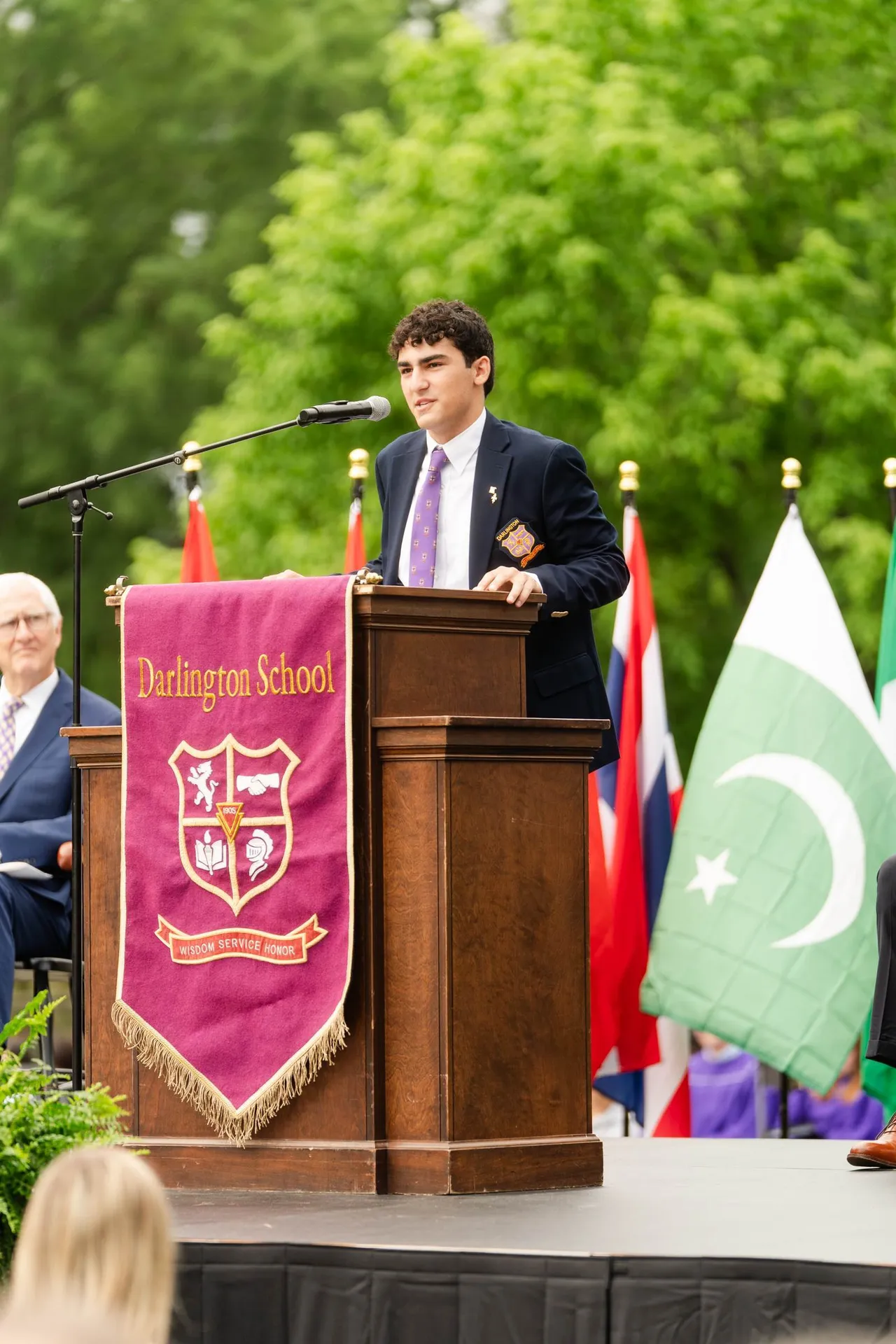 Male student speaks at the podium during Darlington School graduation ceremony