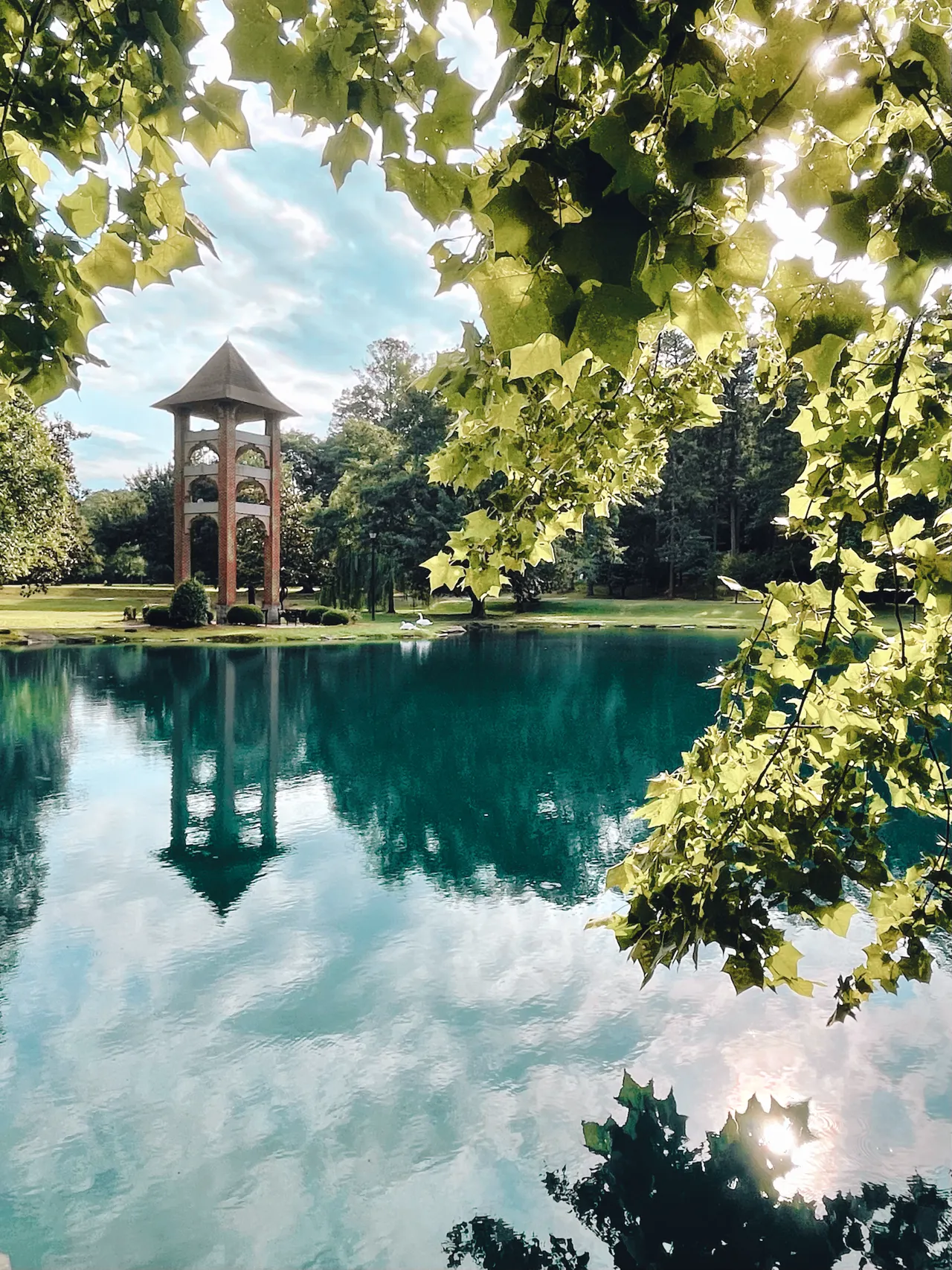 The bell tower reflects onto Silver Lake on the Darlington School campus