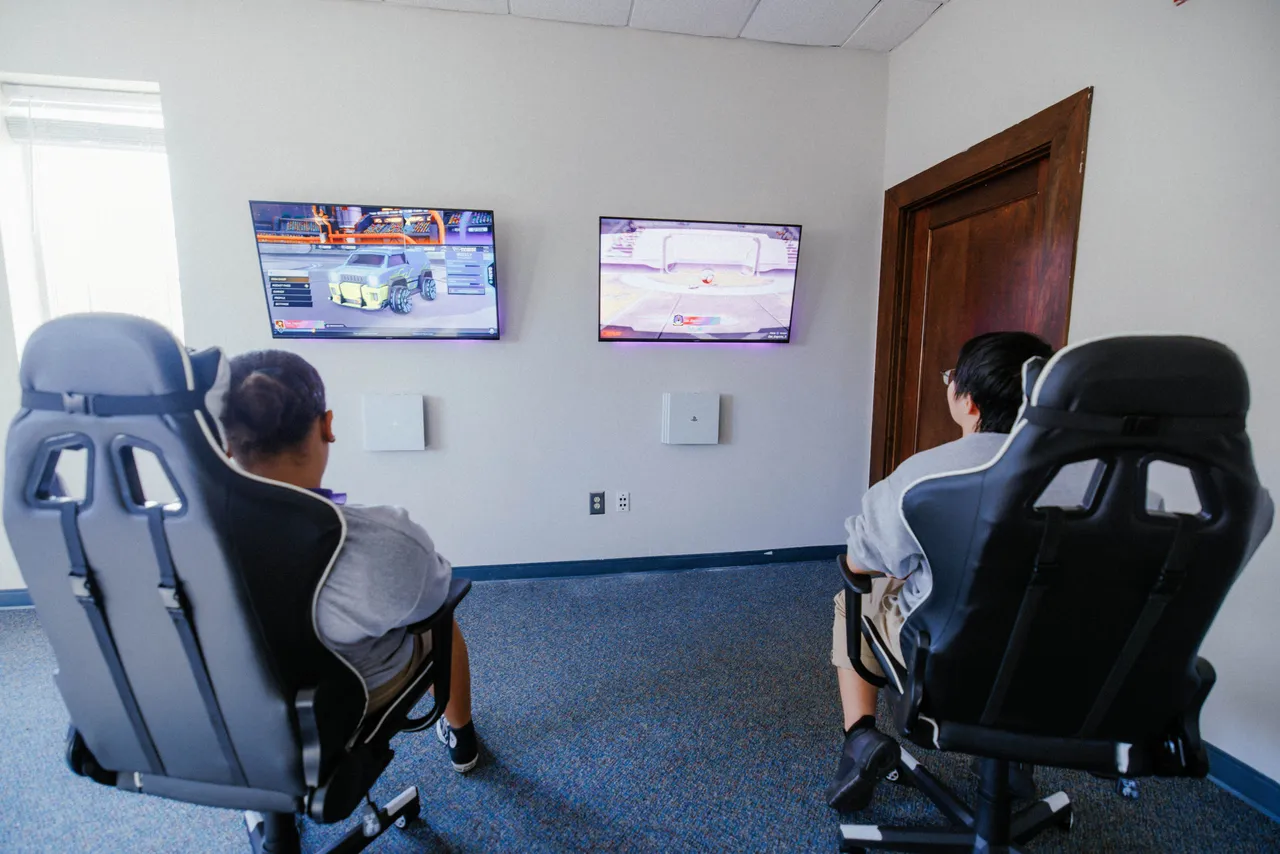 Two boys play video games in an esports match