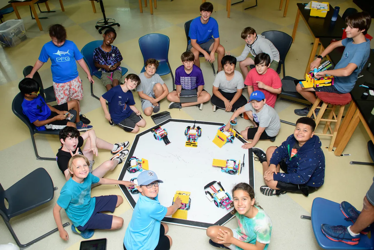 Campers gather around robotics projects during Darlington School's Maker Challenge Camp.