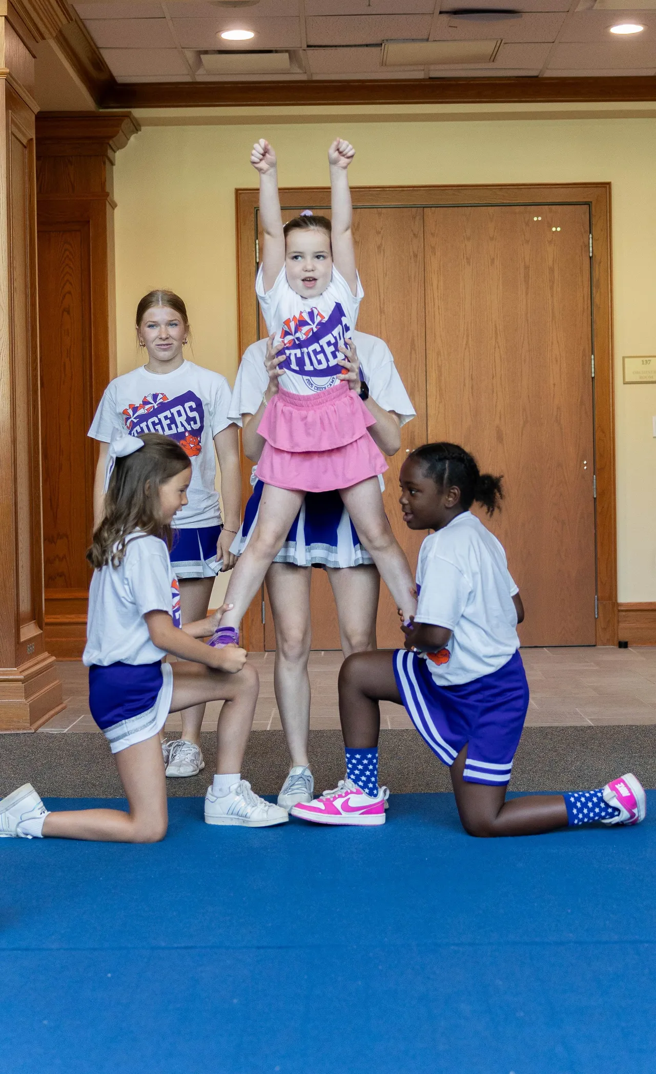 Female campers perform a cheerleading stunt during Darlington School's Cheer Camp.