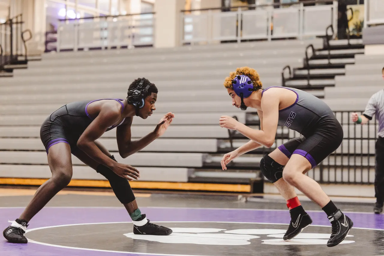 Two male wrestlers compete during a wrestling match.