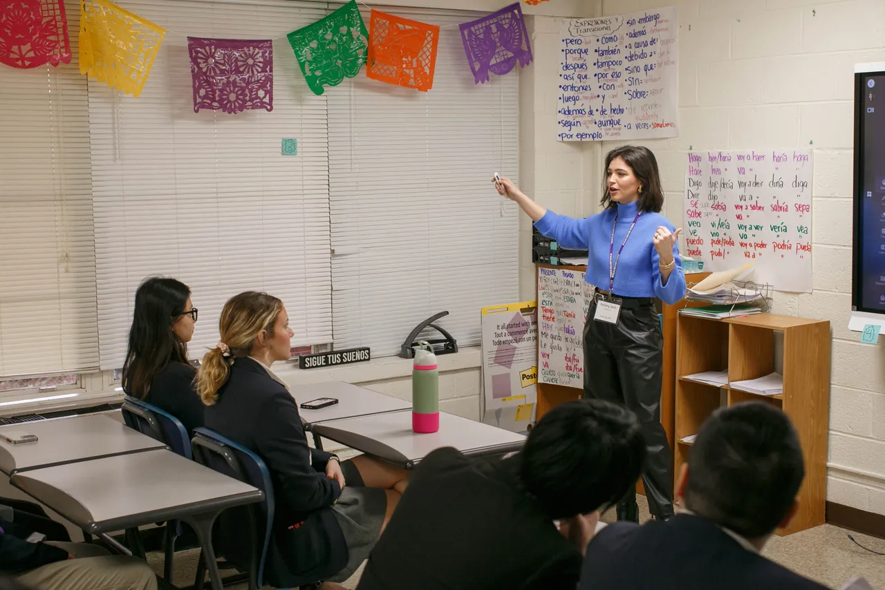 Female Volunteer Leadership participant speaks to students in a classroom.