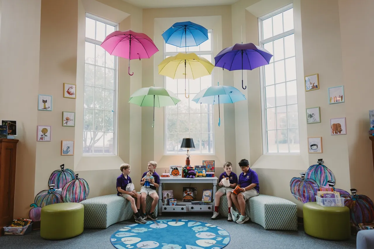 Students gather and read in front of the windows in the Joanne G. Yancey Library at Darlington School's Thatcher Hall