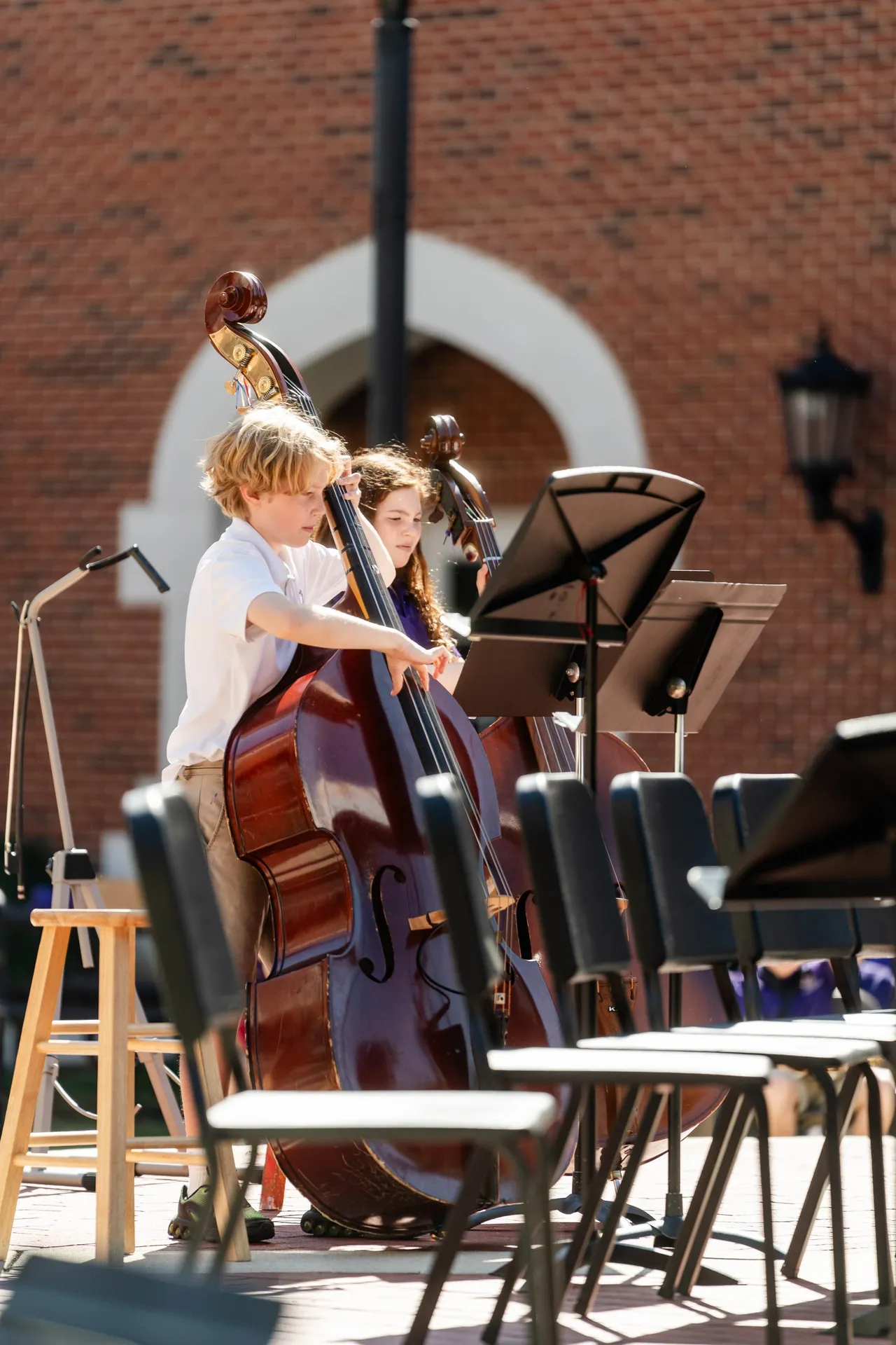 Lower grades students play their instruments at an outdoor band concert
