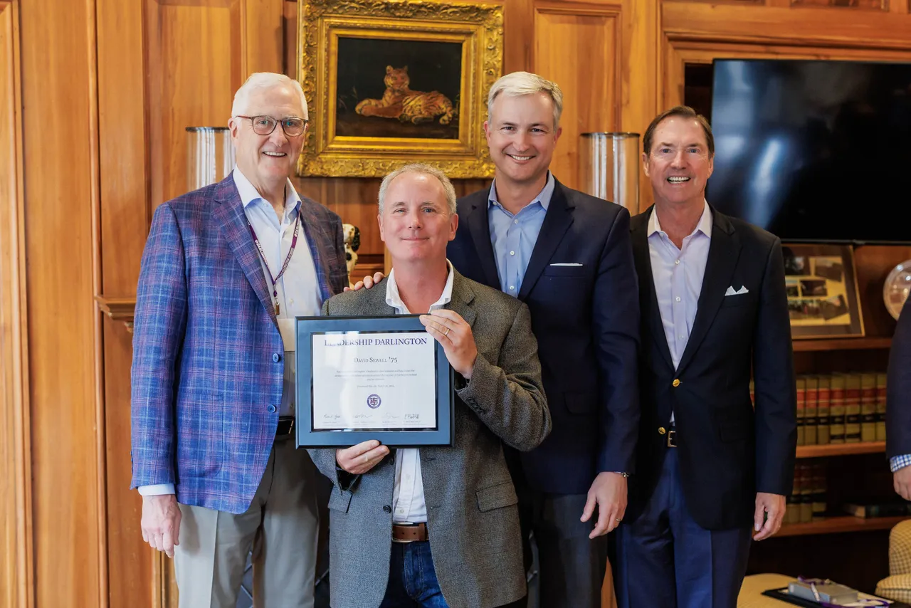 Leadership Darlington alumnus David Sewell pictured holding an award with three others.