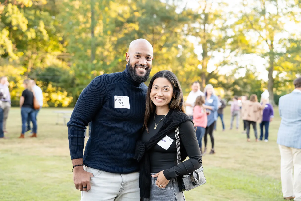 Male and female attendees pose at a Darlington alumni event.