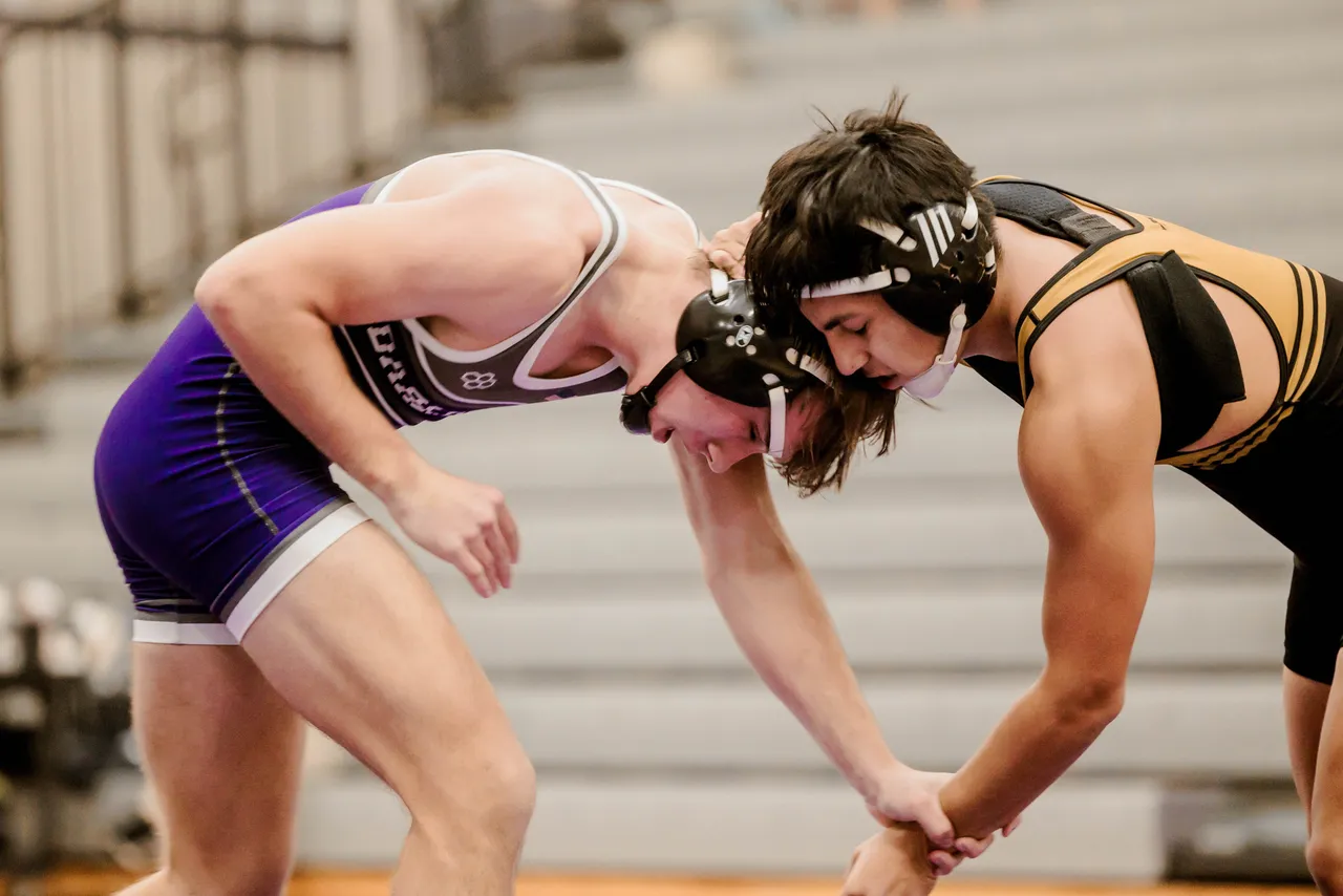 Two male wrestlers compete during a wrestling match.