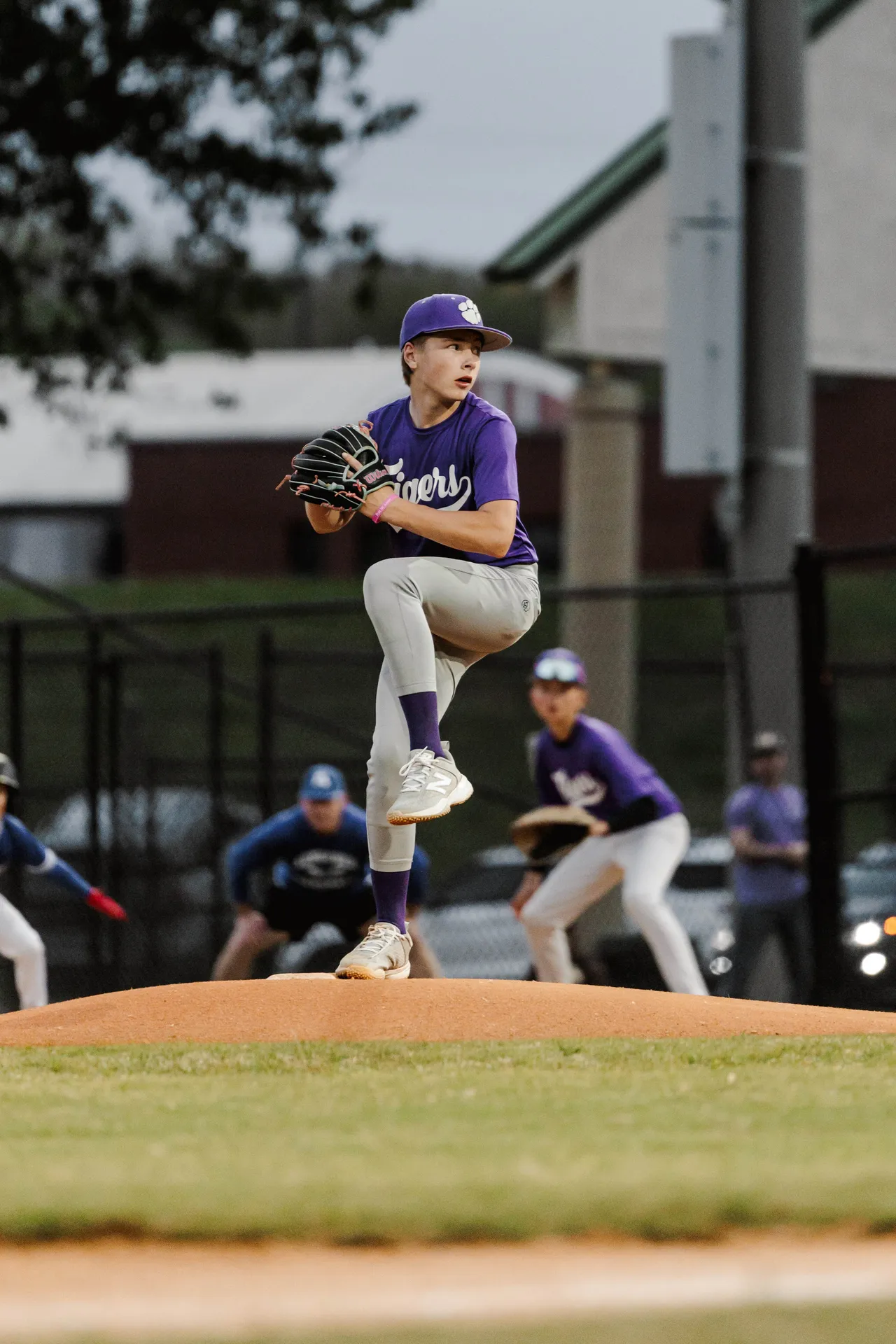 Male middle school student prepares to throw the baseball on the field