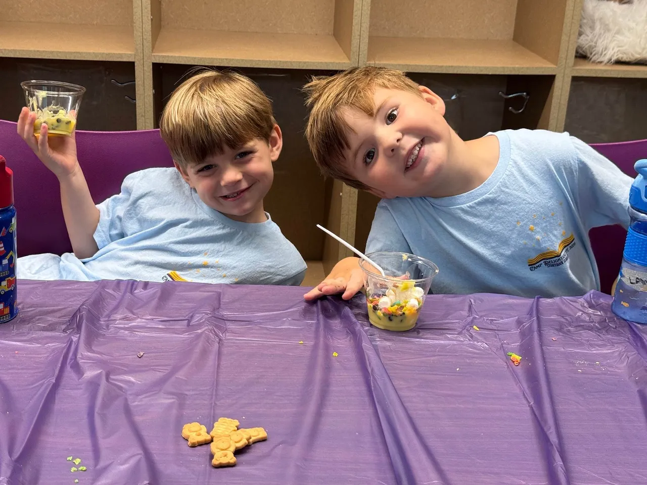 Two young male campers enjoy a snack during Camp Delightascope.