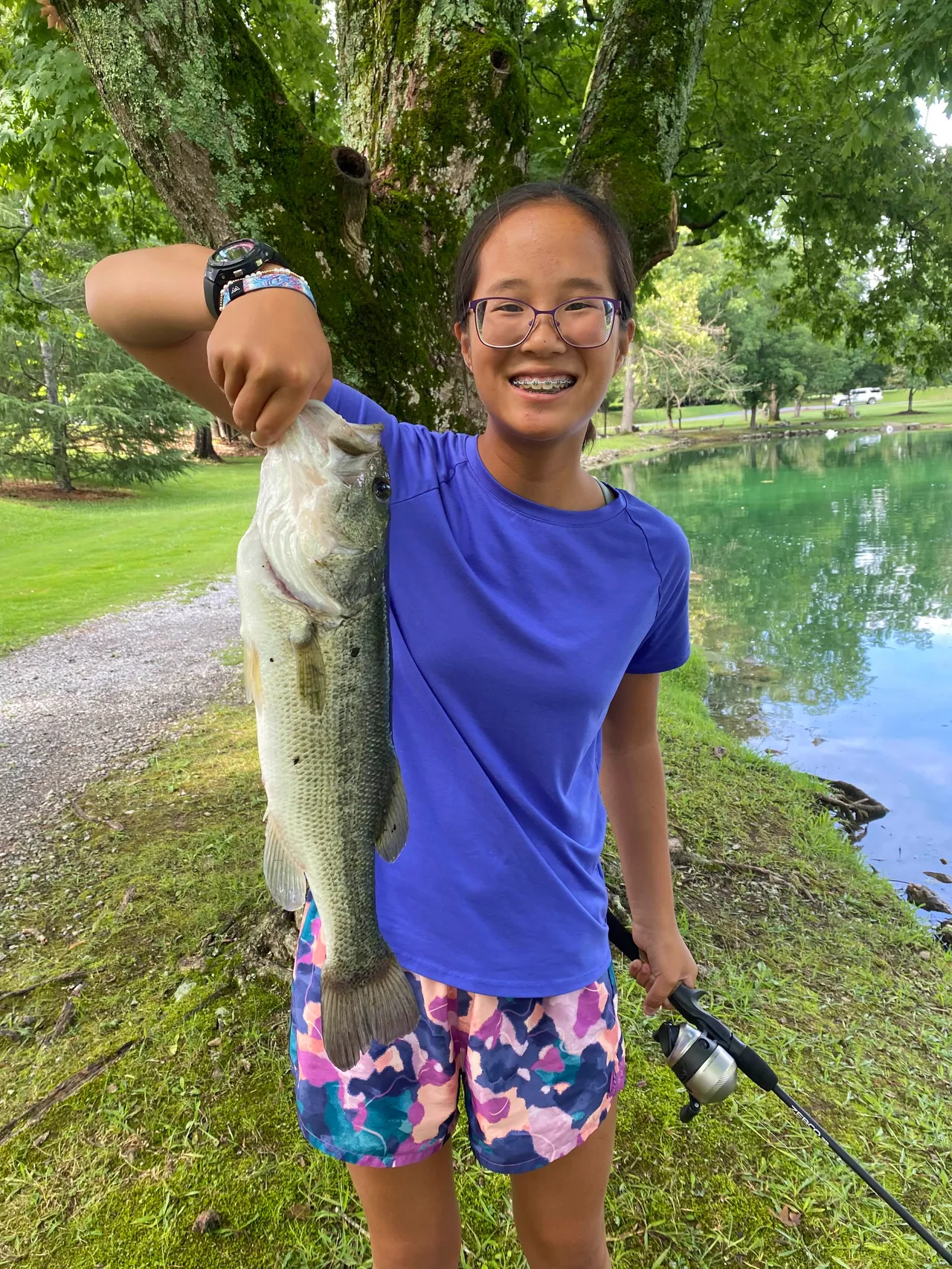 Young female camper shows a fish she caught during Camp Darlington.