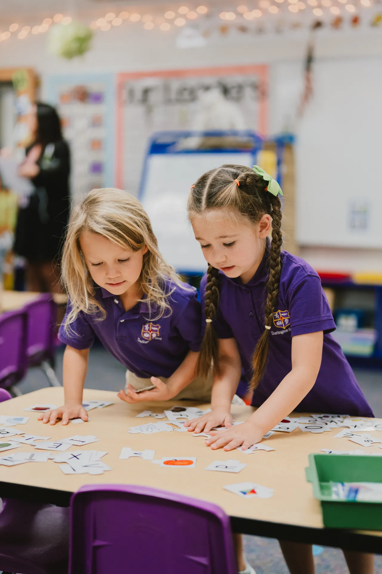Two female primary grades students do a literacy activity in class