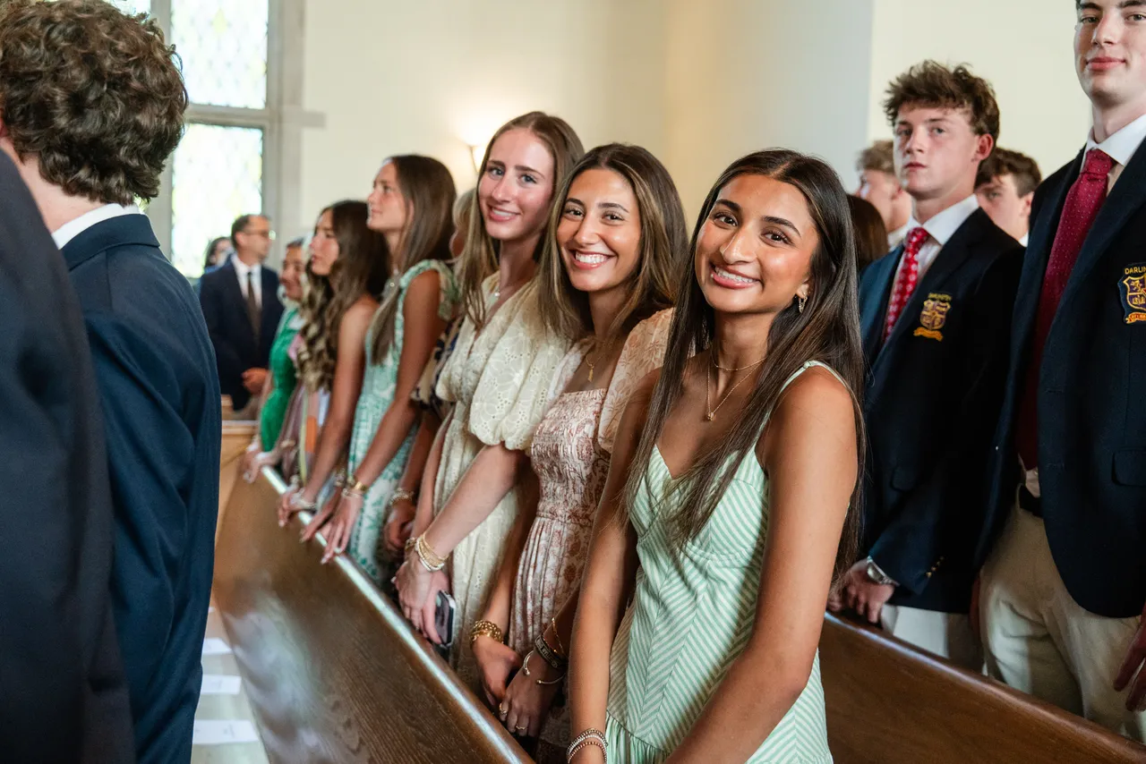 High school seniors smile during Baccalaureate