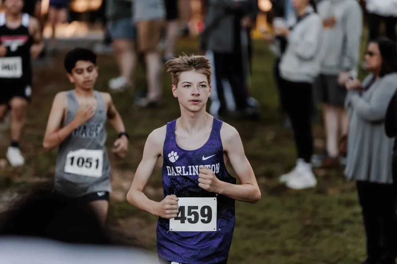 A male JV cross country runner competes in a race.