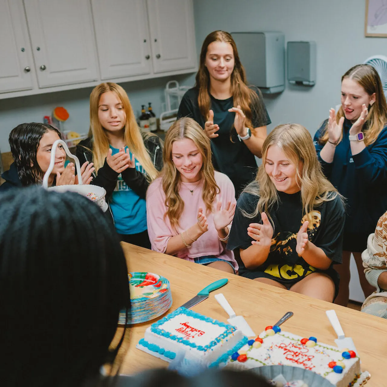 Female boarding students celebrate a birthday in the dorm lounge