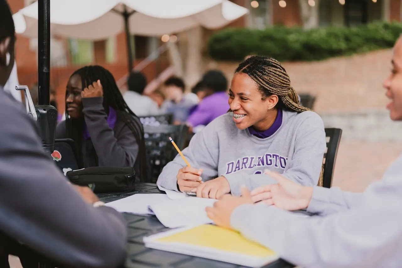 Female upper school student does homework outside during break