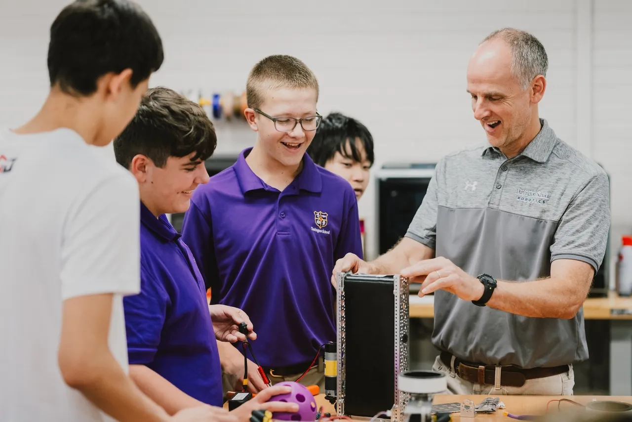 Robotics teacher works with students in the makerspace.