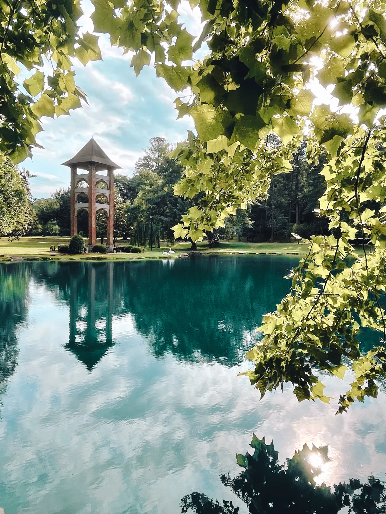 The bell tower reflects on Silver Lake on the Darlington School campus
