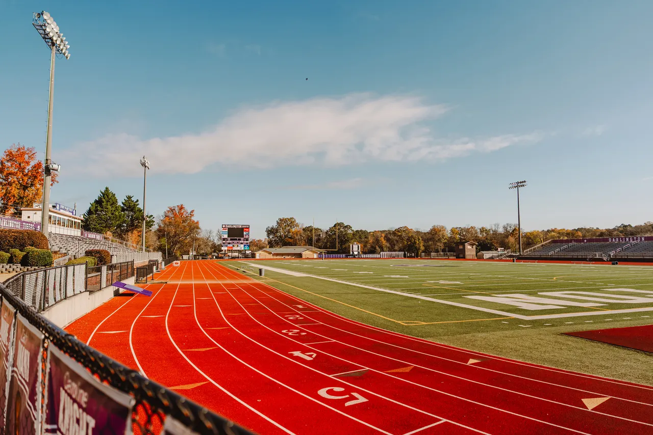The football field surrounded by the track and stadium seating at Darlington School
