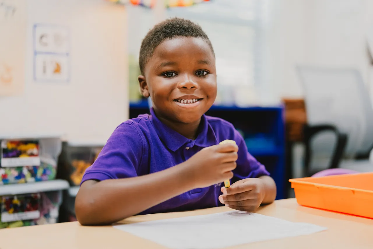 Male primary grades student does an interactive learning activity during class