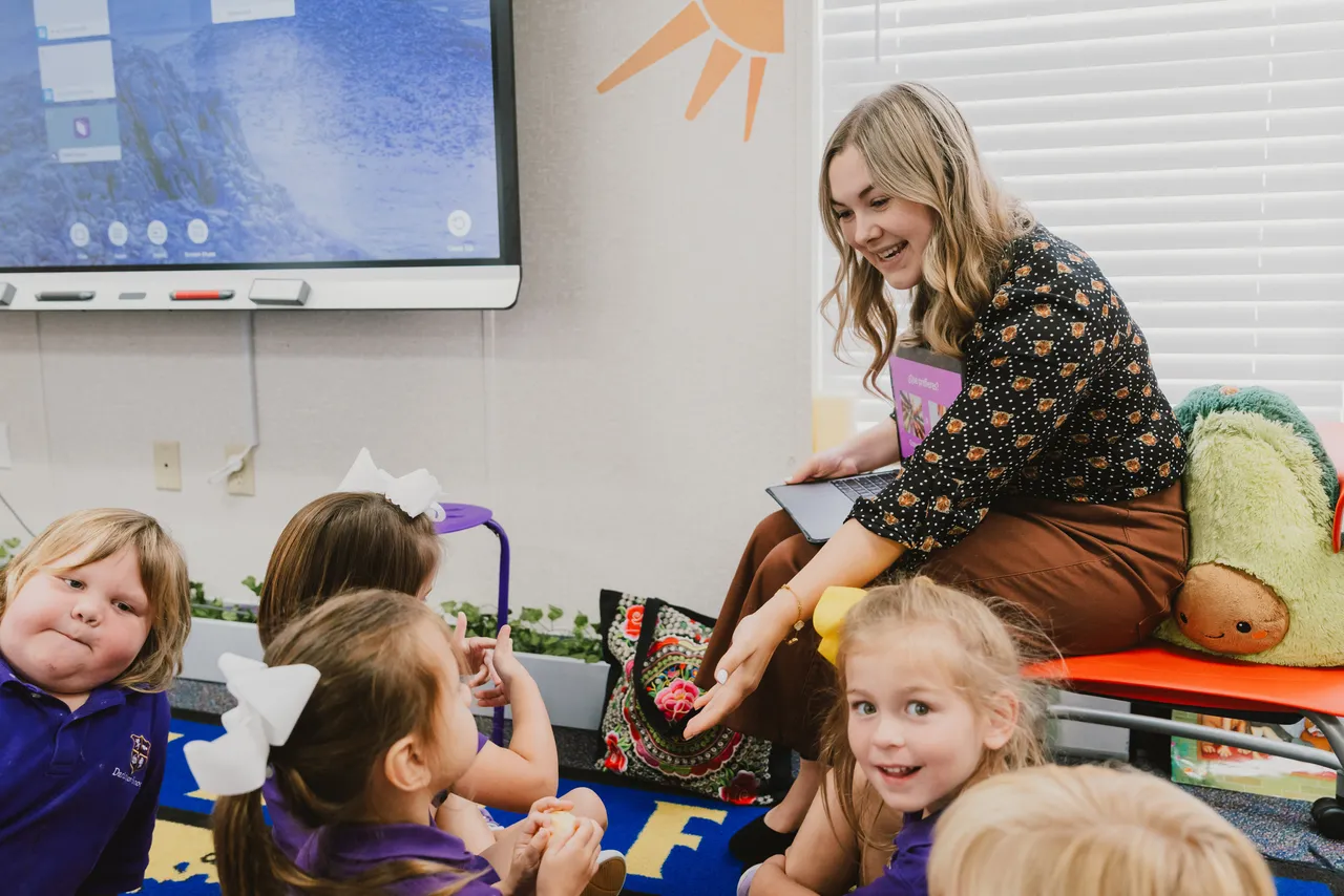 Female Spanish teacher reads a book to pre-K students during Spanish class
