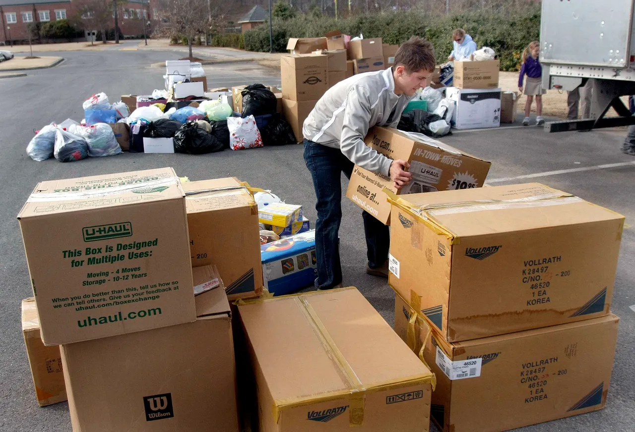 03012010HaitiSupplies3; Miles Englis carries a box of supplies to a trailer to be shipped to Haiti at Darlington School on Monday afternoon.(Ken Caruthers/RN-T.com)