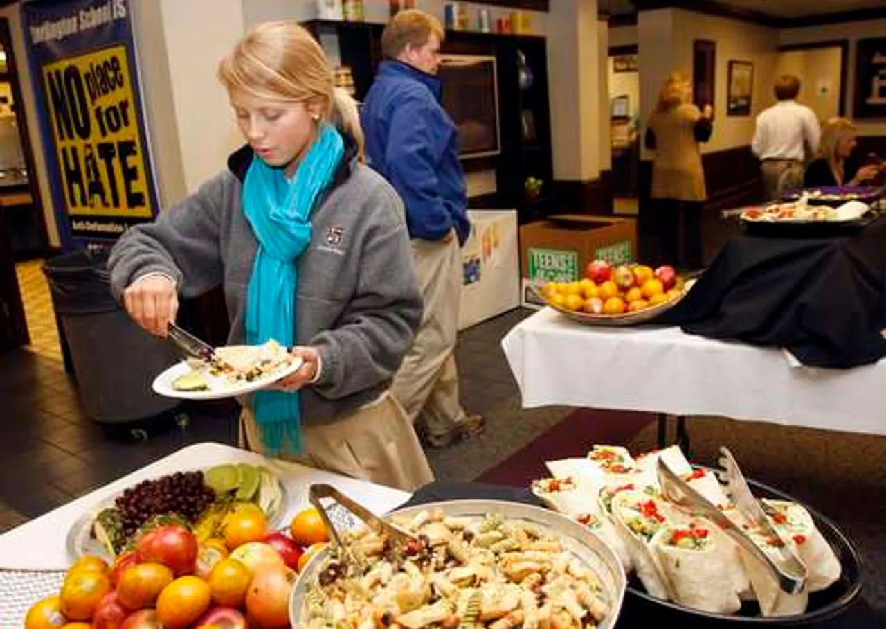 ColdLunch012910b; Darlington senior Allie Evans puts fruit on her plate for lunch at the school. Darlington is participating in a contest to conserve resources this month with Fridays being a cold lunch day. (Ken Caruthers/RN-T.com)