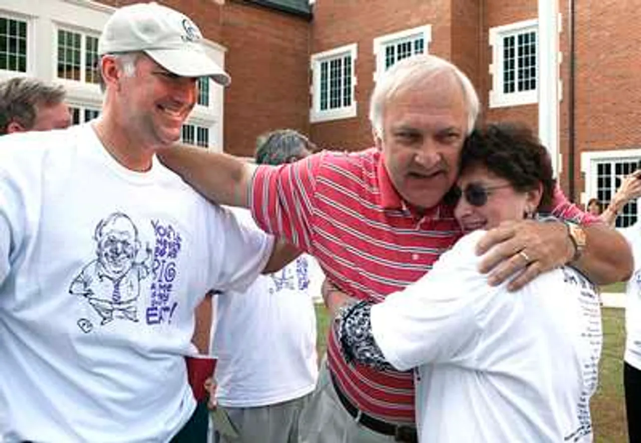 VanEs2: Jim Van Es (center), gets hugs from Chris Jefts and Gena Agnew on Thursday during a ceremony honoring his career at Darlington Middle School. (Ryan Smith, RN-T.com)