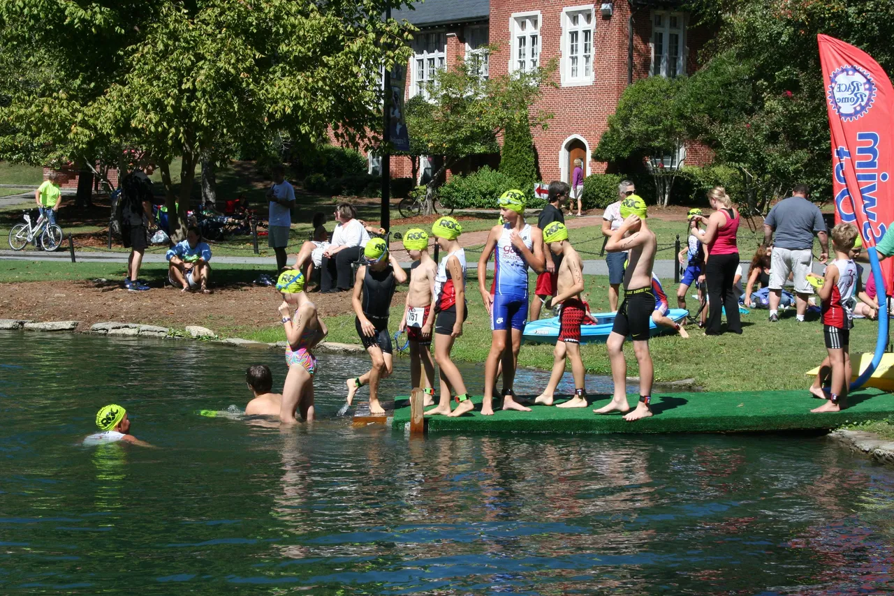Swimmers line up to test the water's temperature before the kids' portion of the race during the RACE Rome Triatholon at Darlington School Sunday morning. (Nick Godfrey RN-T)