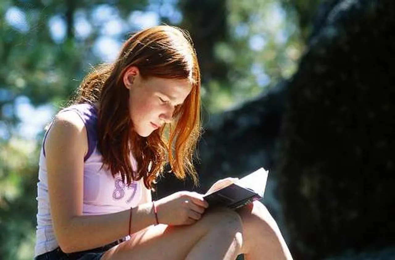 Teenage girl reading a book.