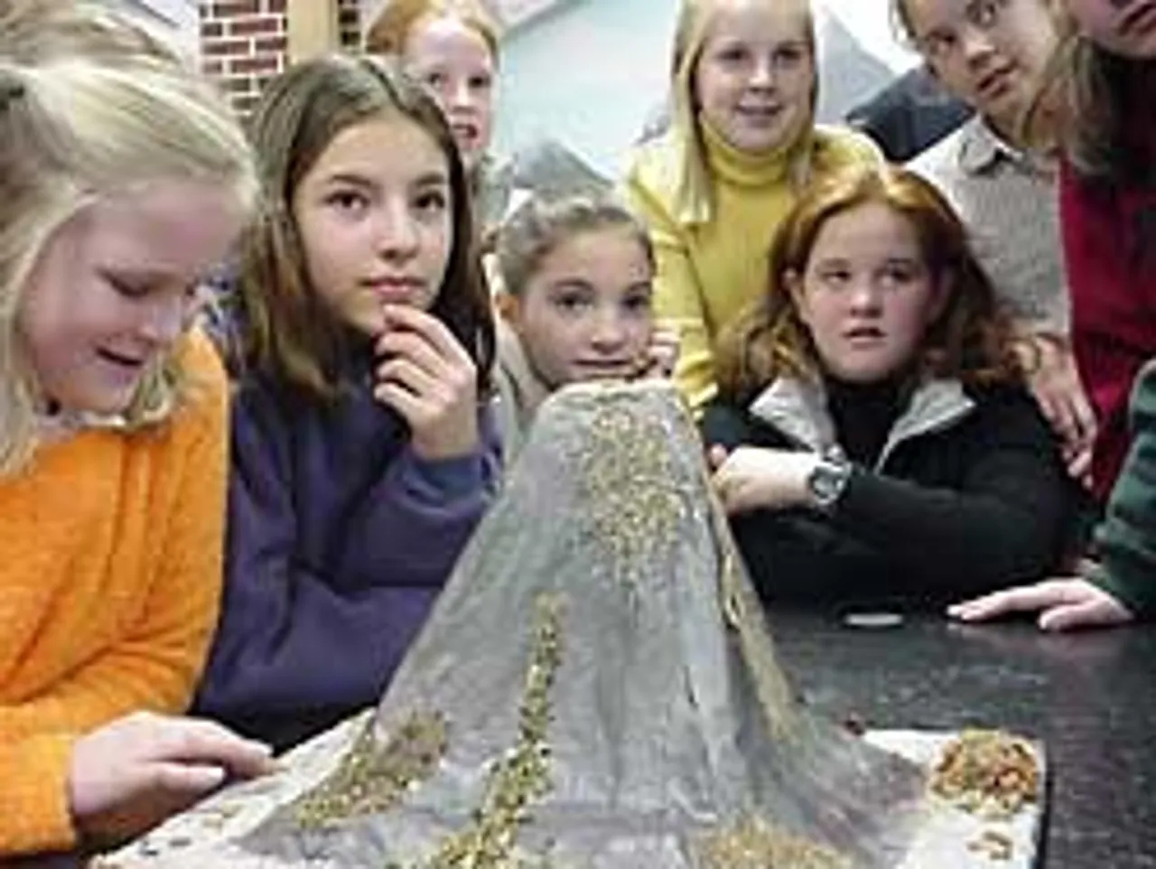 While anxiously awaiting a volcanic eruption, sixth-graders listen to a description of what to expect.