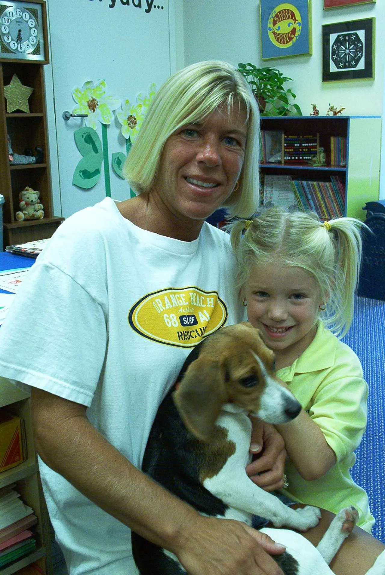Savannah Winn and her mother share their new puppy with classmates during Show and Tell.