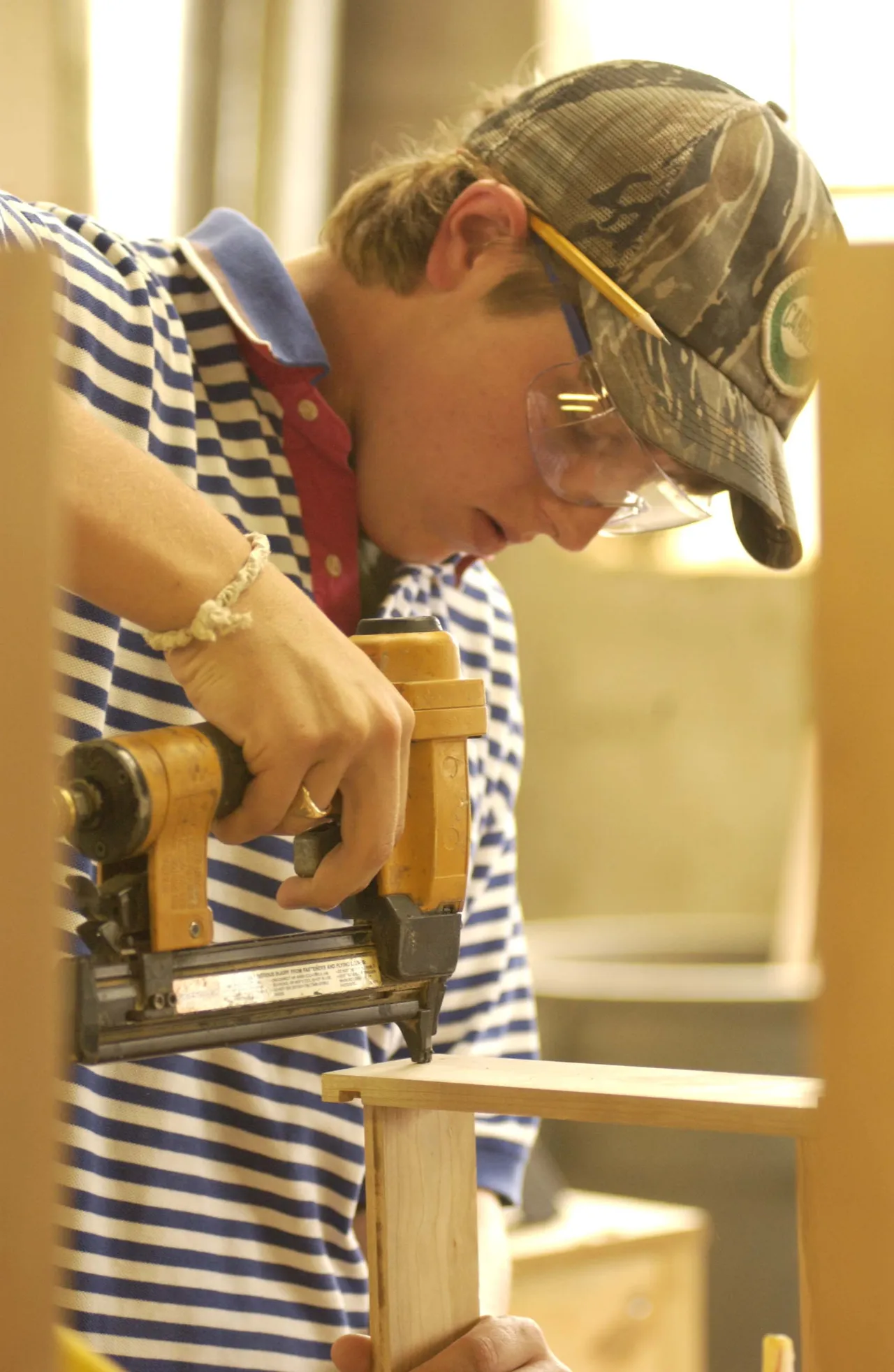 Senior Thomas Frazer tacks his drawer together with a nail gun.