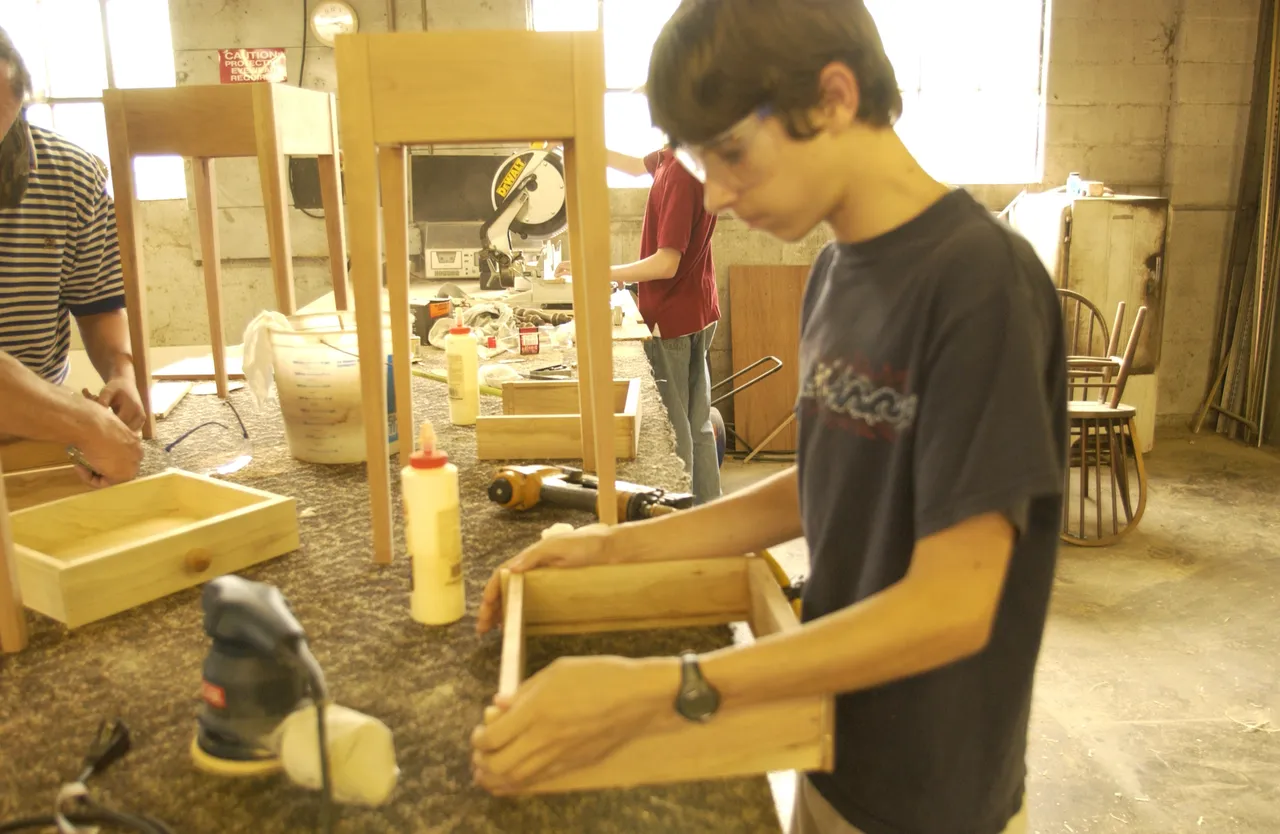 Brian Albury works on his end table as part of the new woodworking ASA.