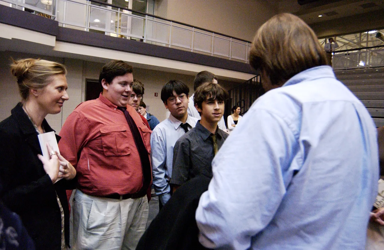 Students get Bragg to autograph their books after his presentation.