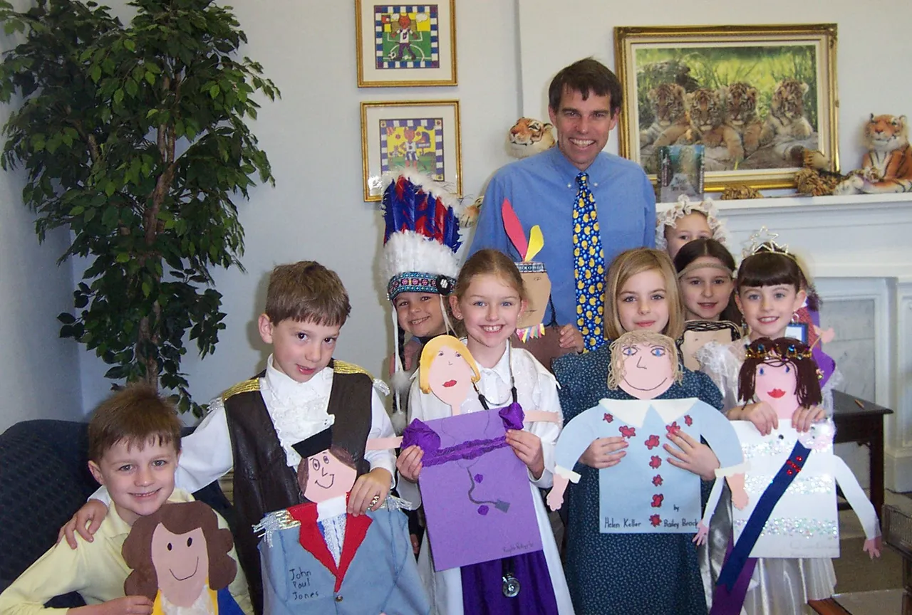 Second graders show off their costumes to Lower School principal Mark Tayloe.