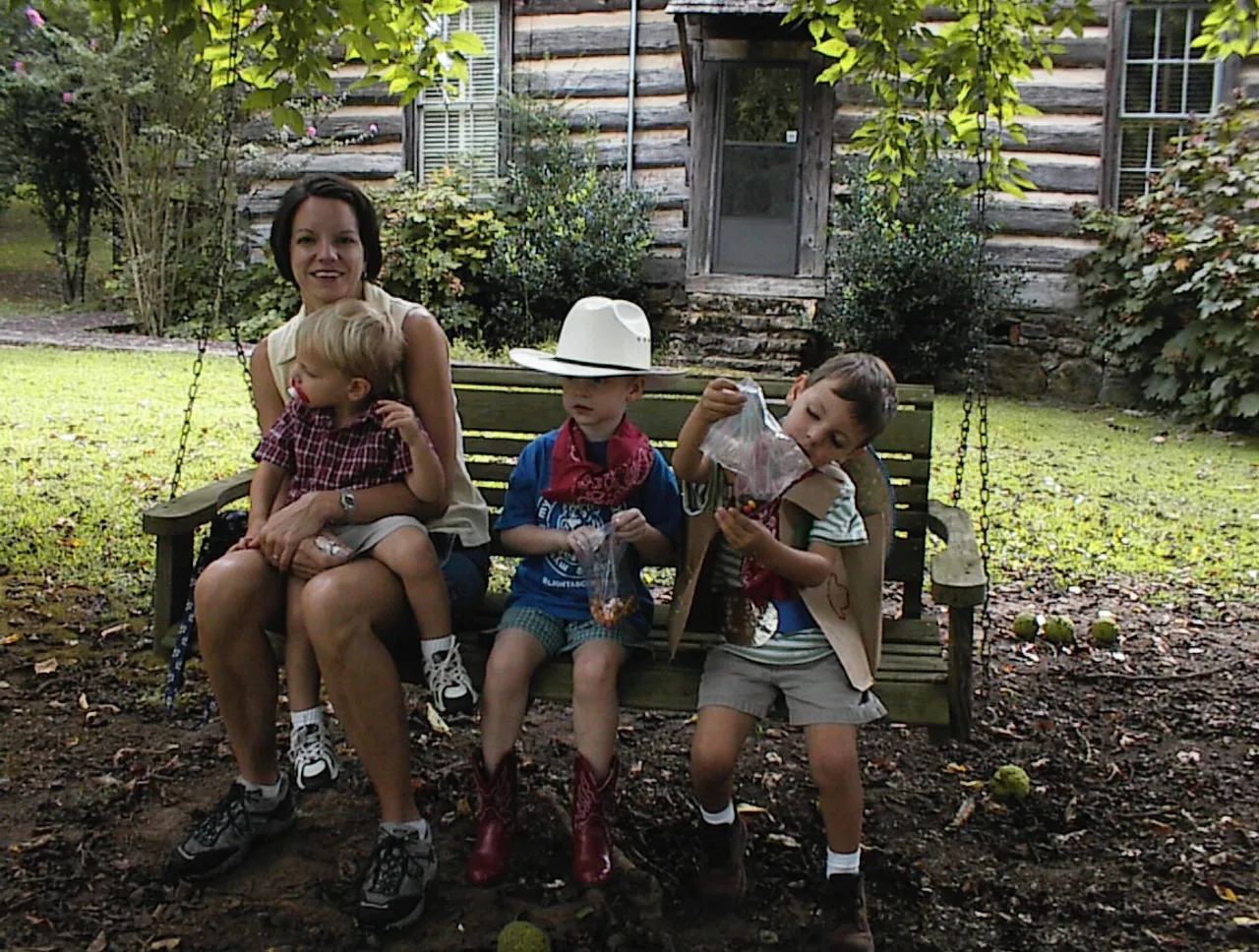 Parent Rebekah Kinney and her son Elliott break from the Wild West action to enjoy a swing and trail mix with pre-kindergartens Benjamin DiRuggerion and Ian Kinney.