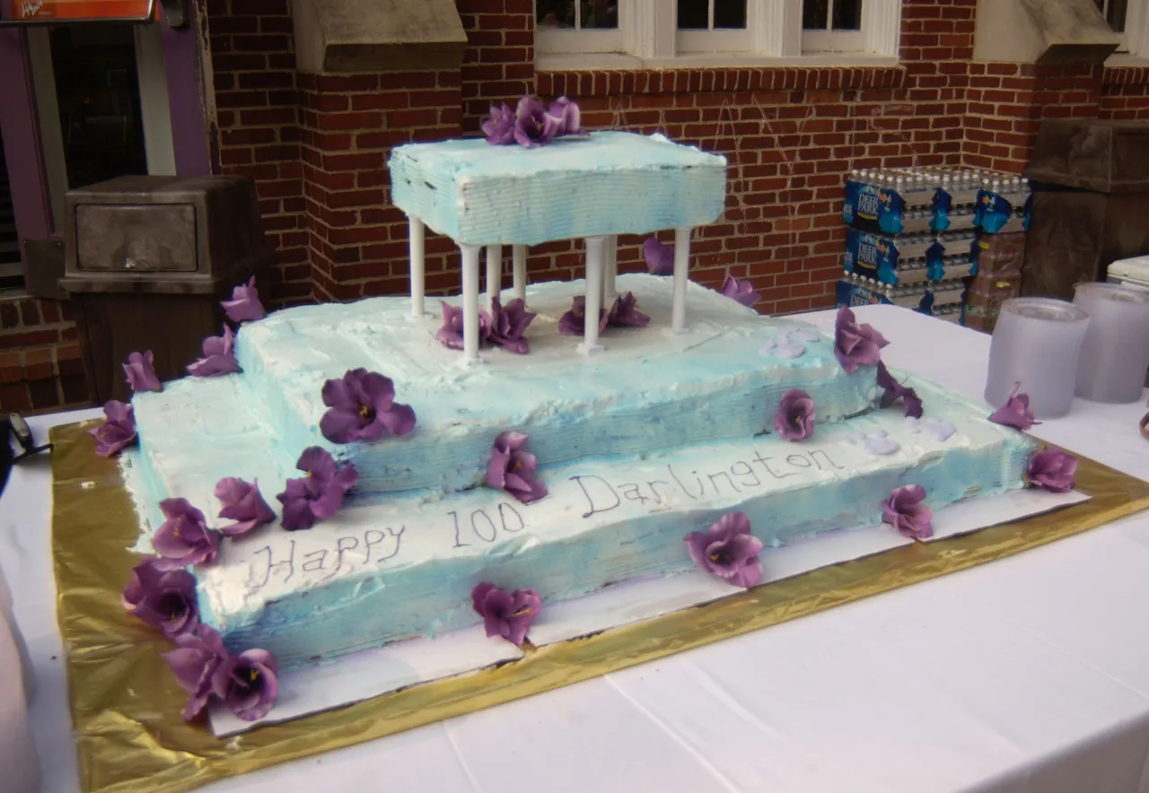 The Darlington community celebrates 100 years with a birthday cake.