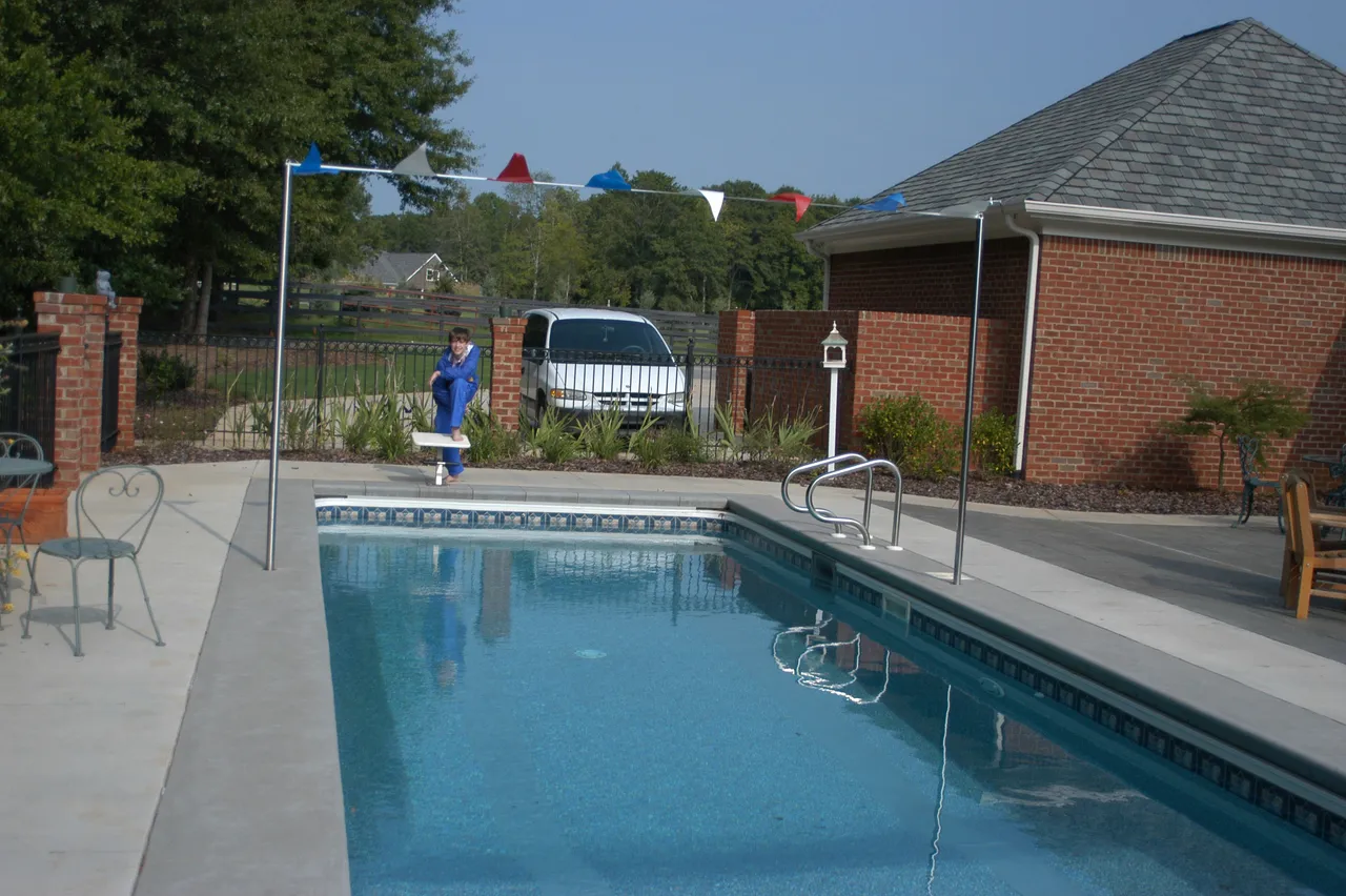 The Bryant family's home training pool is a full-length 25-yard lap pool with two lanes, an official starting block and a lane divider.