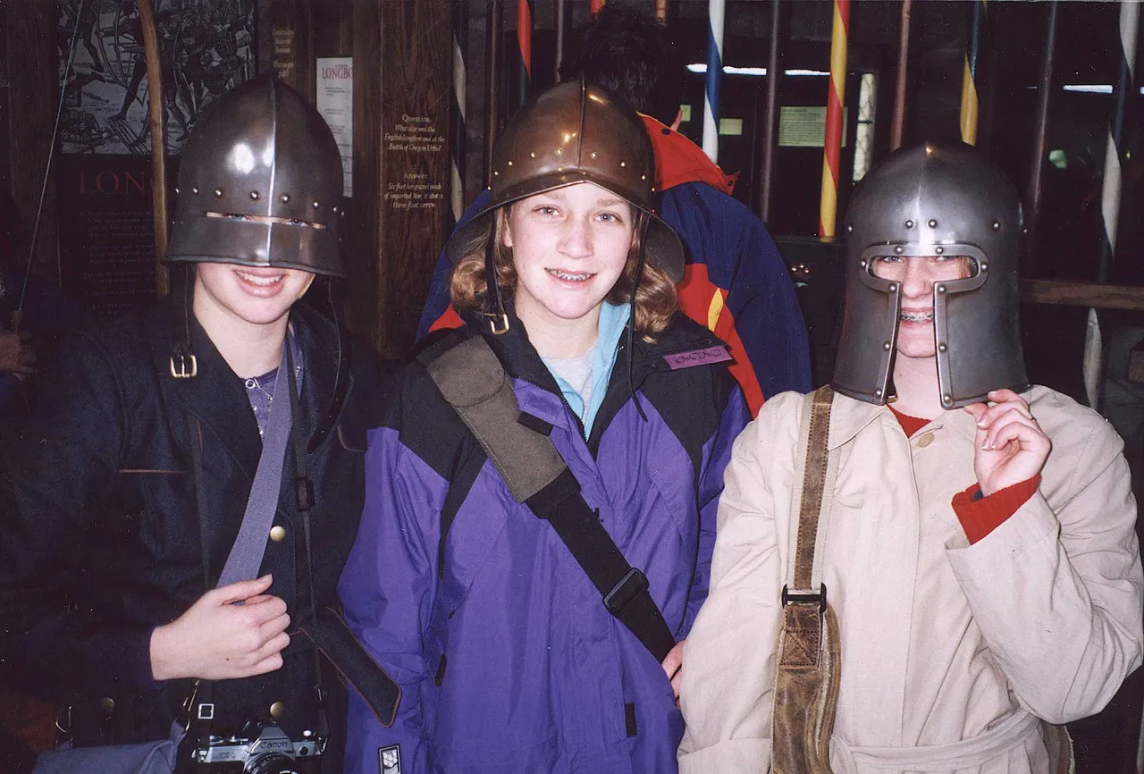 Students pose in medieval armor.