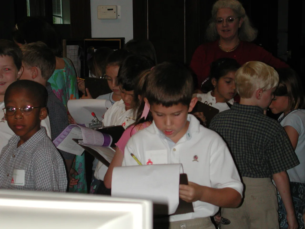 Second-graders visit the Upper School library and take notes as part of their career day field trip.